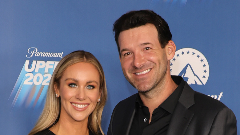 Tony Romo and Candice Romo at an event