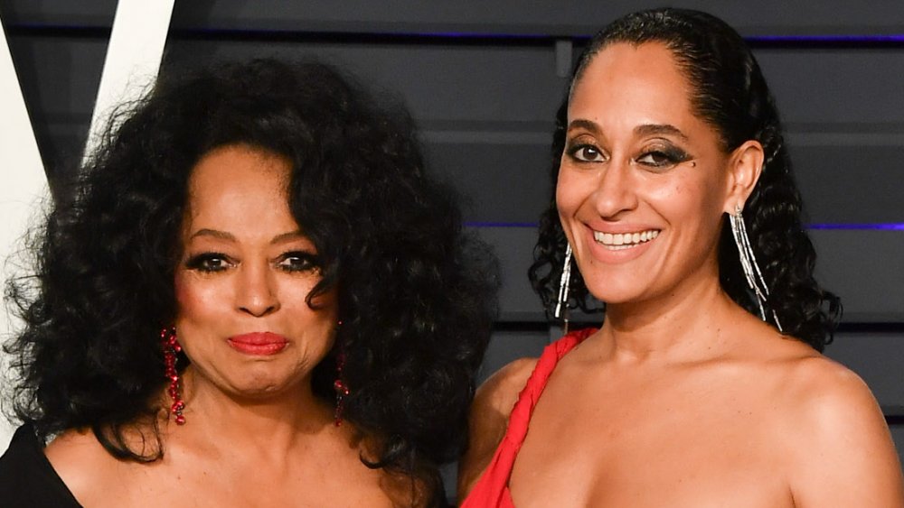 Diana Ross in a black dress and Tracee Ellis Ross in a red dress, posing at the 2019 Vanity Fair Oscars Party