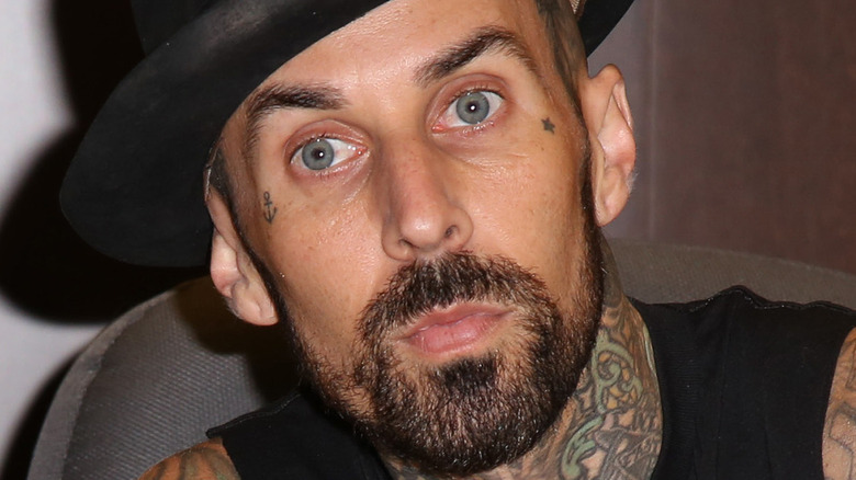 Travis Barker with serious expression and hat