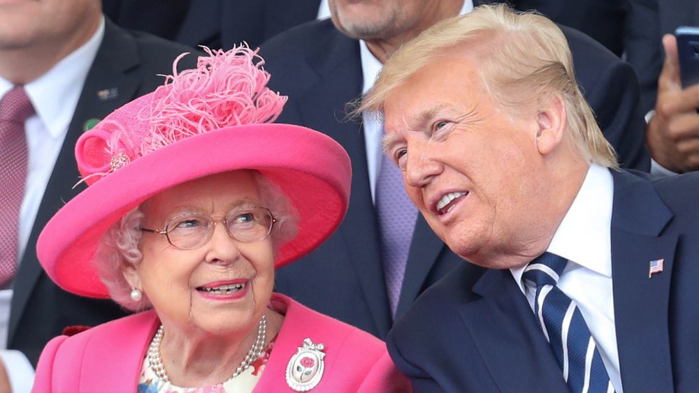 The Queen in a pink ensemble next to Donald Trump