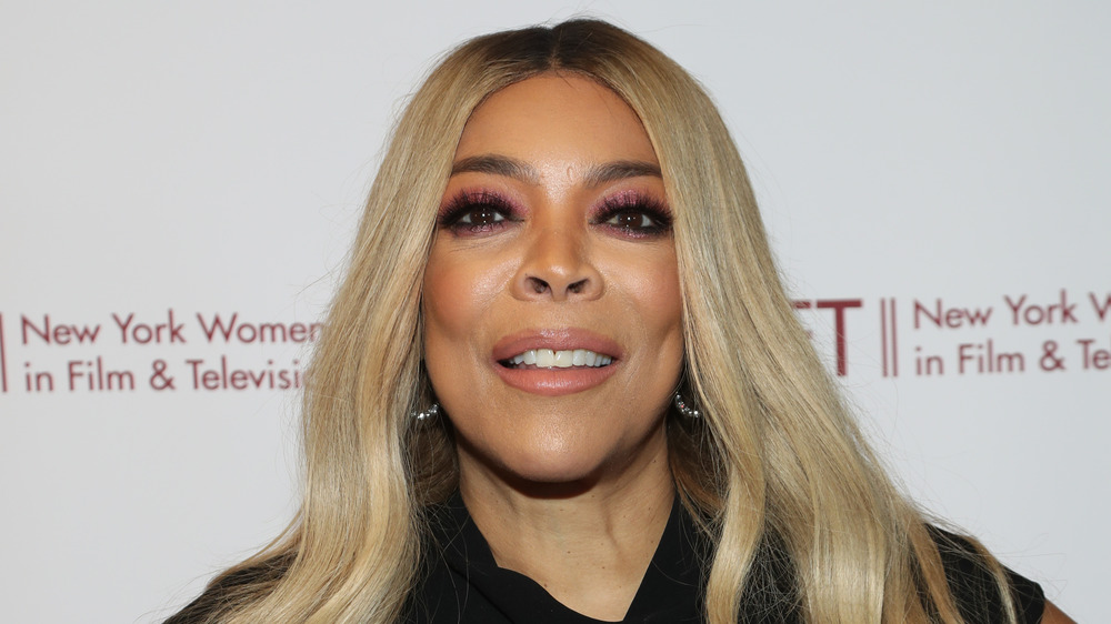 Wendy Williams, smiling, blond hair down, black dress, red carpet 