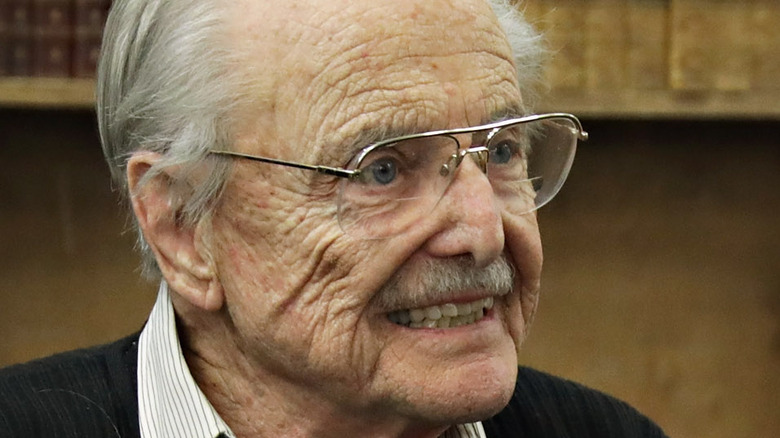 William Daniels smiling and signing copies of his book