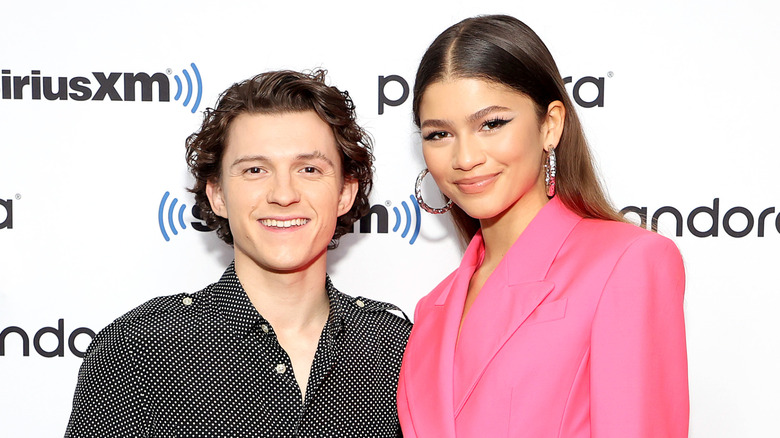 Tom Holland and Zendaya grinning