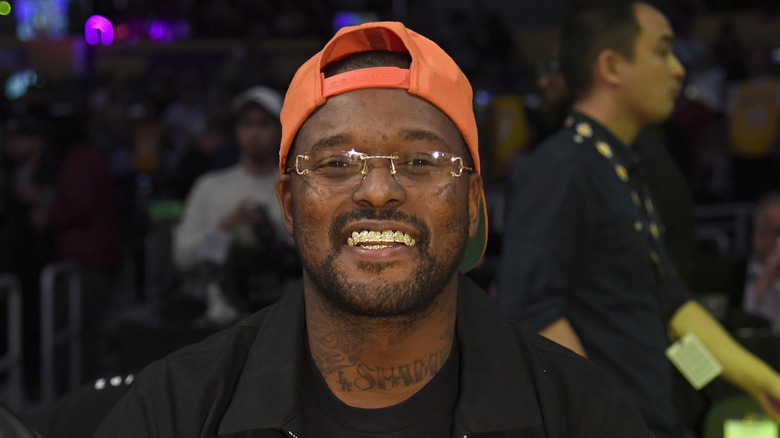Schoolboy Q with neon orange cap, grinning
