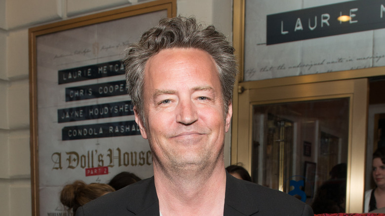 Matthew Perry smiling stubble