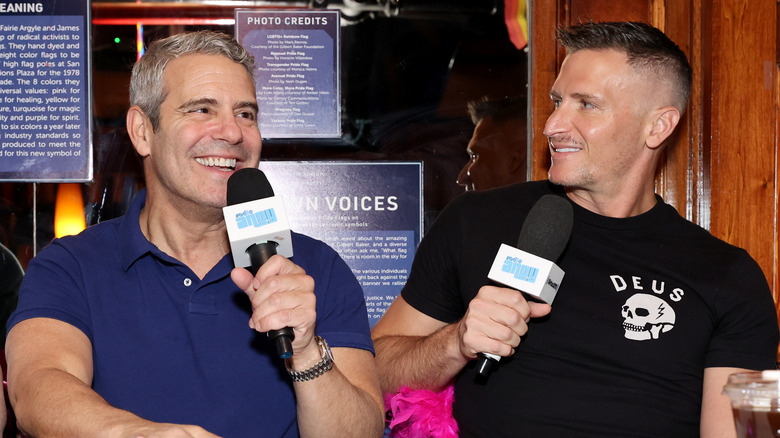 Andy Cohen and John Hill smiling