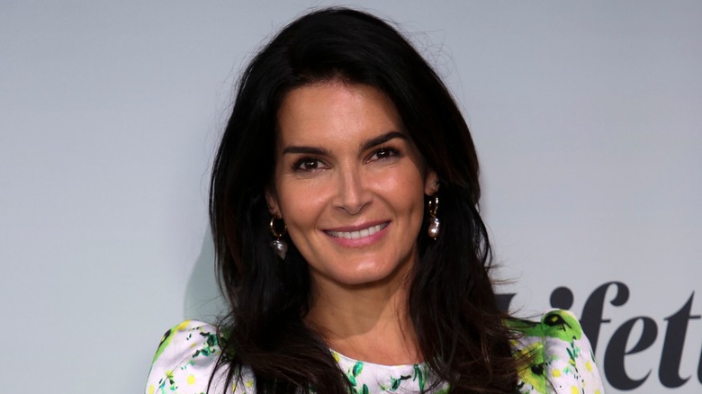 Angie Harmon smiles with hair down
