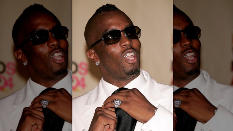 Sean Diddy Combs adjusting tie
