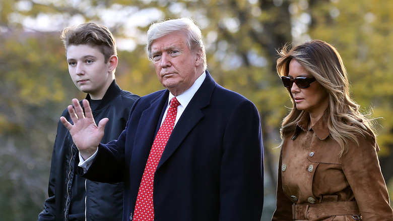 Donald Trump walks with Barron and Melania