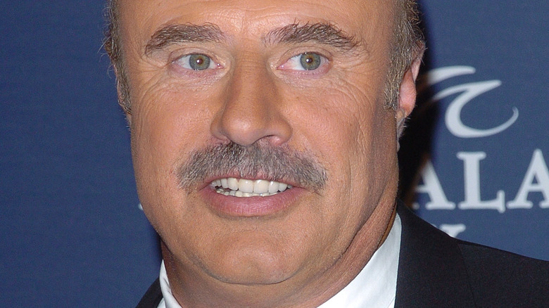Dr. Phil smiling on the red carpet