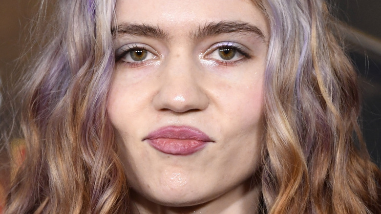 Grimes puckers her lips