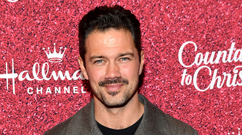 Ryan Paevey smiles on the red carpet