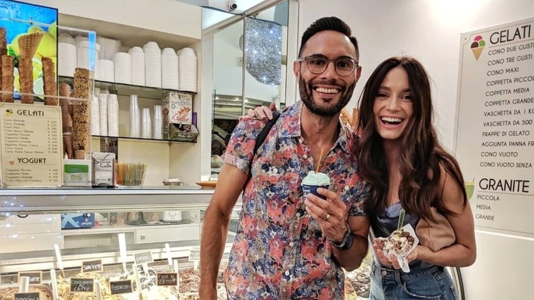Mallory Jansen posing with her husband, Simon Phan, inside a gelati shop.