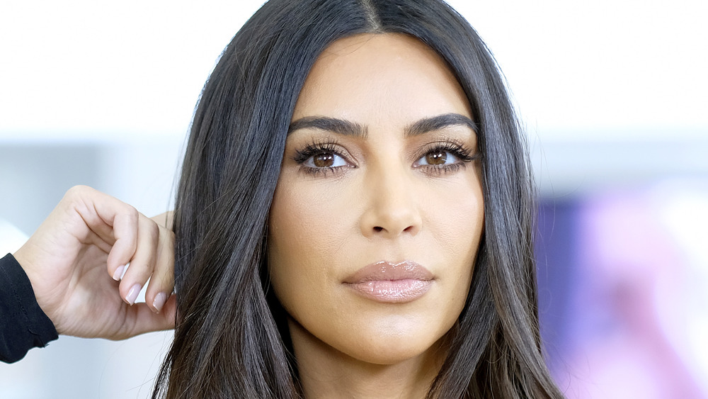 Kim Kardashian posing with her hand on her head