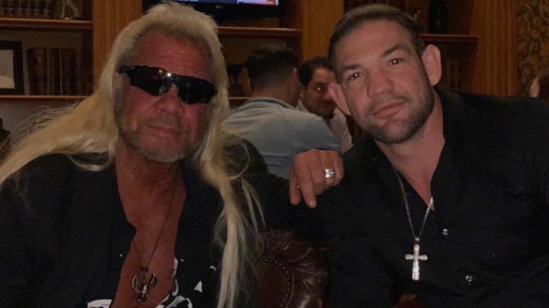 Duane Chapman and Leland Chapman posing together at a restaurant