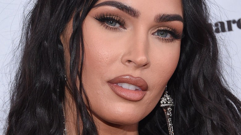 Megan Fox poses in drop earrings