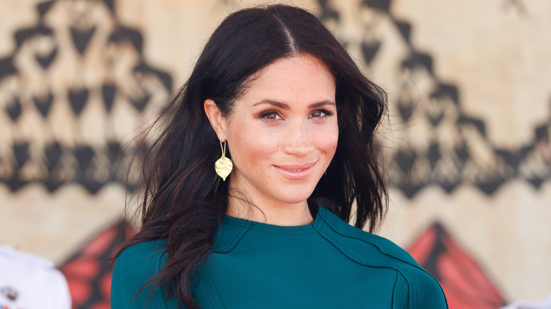 Meghan Markle looking on