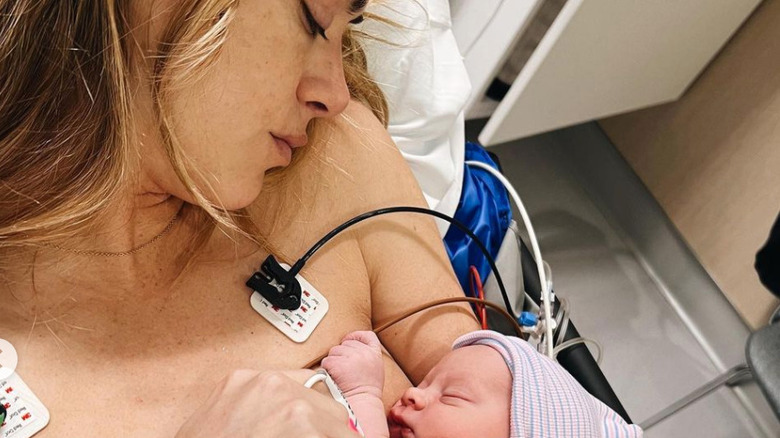 Emily Wickersham lays in her hospital bed with her newborn son, Cassius