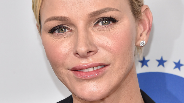 Princess Charlene smiles at an engagement