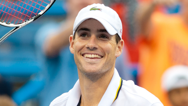 John Isner smiles at a 2013 tennis competition