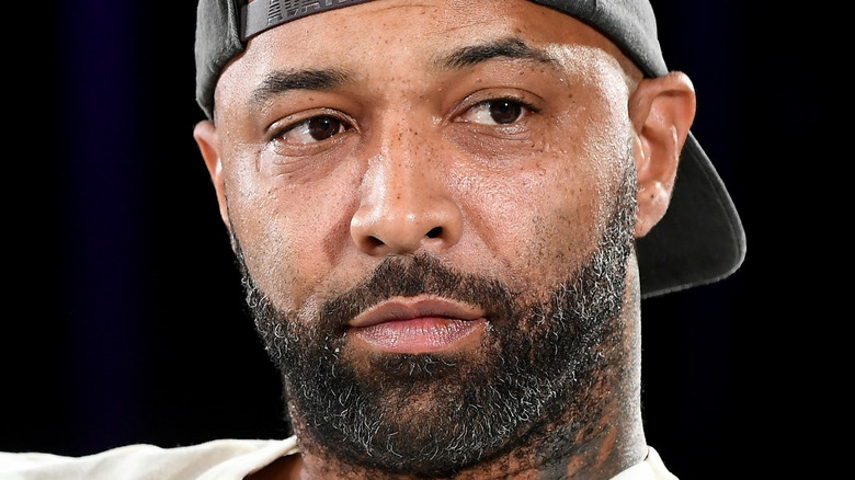 Joe Budden wearing a black hat