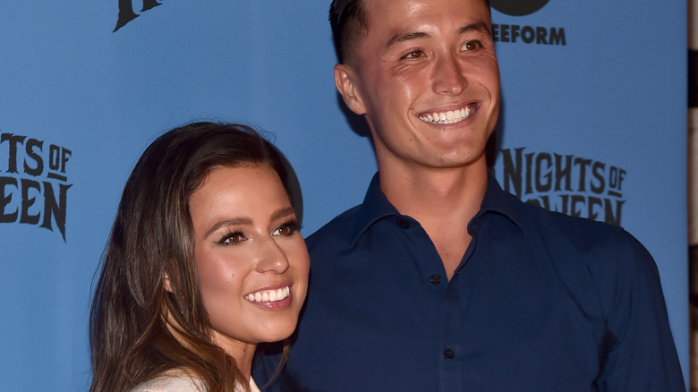Katie Thurston and John Hersey smiling on red carpet