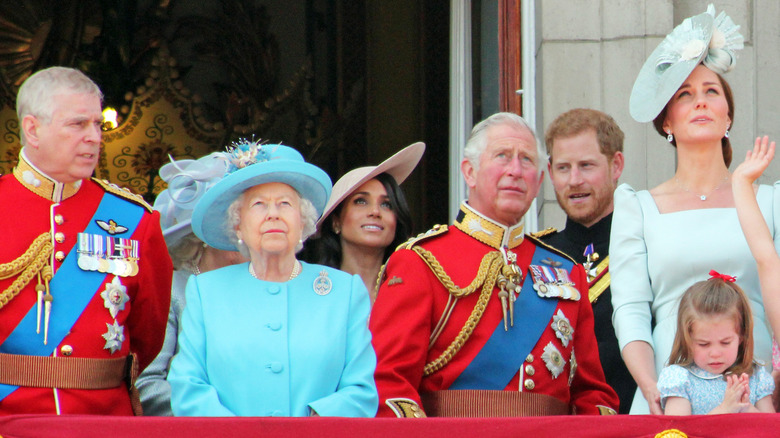 The royal family standing on a balcony