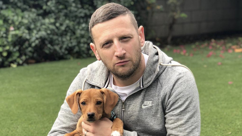 Tim Robinson holding a puppy