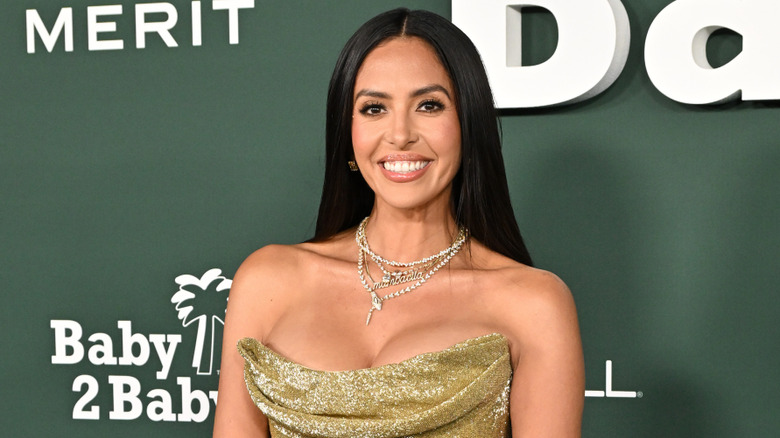 Vanessa Bryant smiling on the red carpet in sparkly gold dress