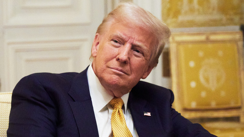 Donald Trump in the oval office with his head bend to the side