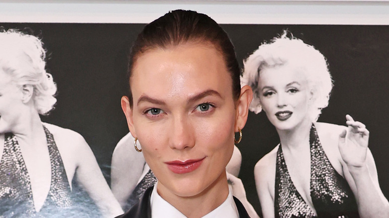 Karlie Kloss in front of Marilyn Monroe pictures