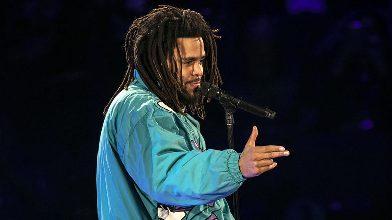 J. Cole performing on stage