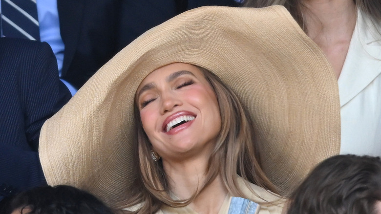 Jennifer Lopez pictured laughing at Wimbledon in a big hat