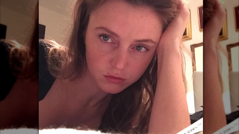 Lorraine Nicholson resting her head on her hand while taking a selfie.