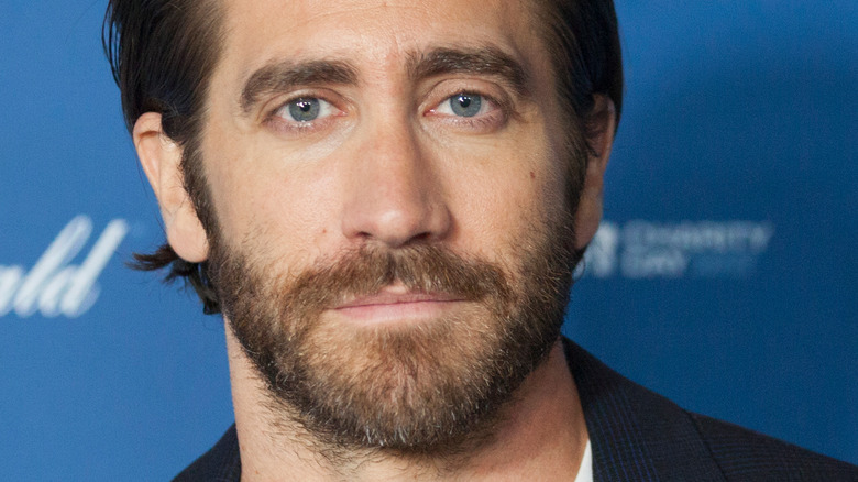 Jake Gyllenhaal staring at camera with solemn expression