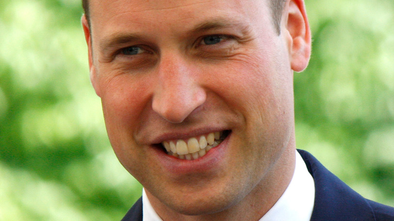 Prince William smiles in a navy suit