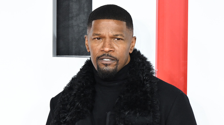Jamie Foxx wearing black coat