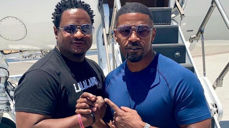 Keith Jefferson and Jamie Foxx in front of plane