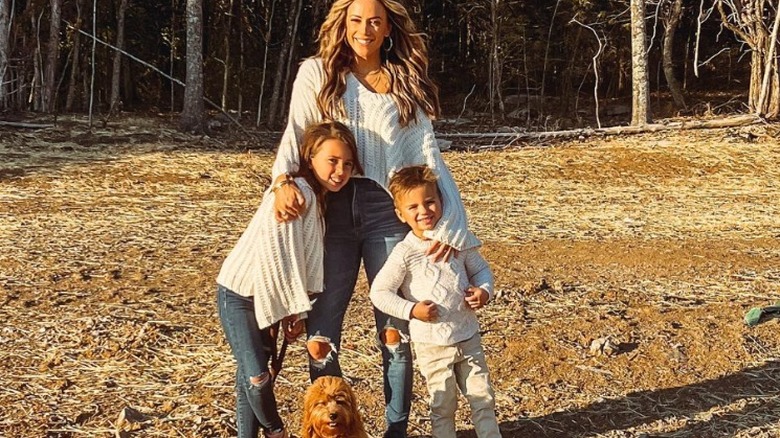 Jana Kramer stands with her children and dog