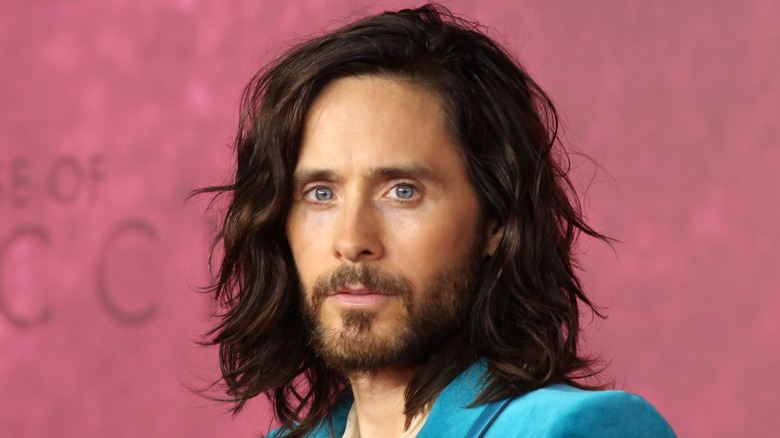 Jared Leto poses in teal blazer
