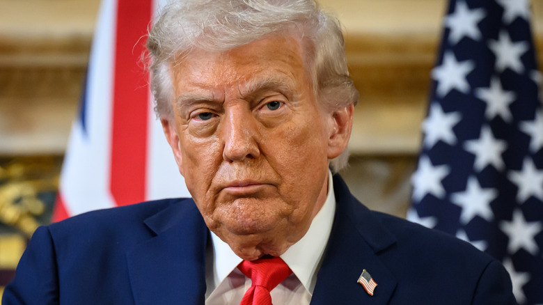 Donald Trump looks straight ahead during a meeting in the UK.