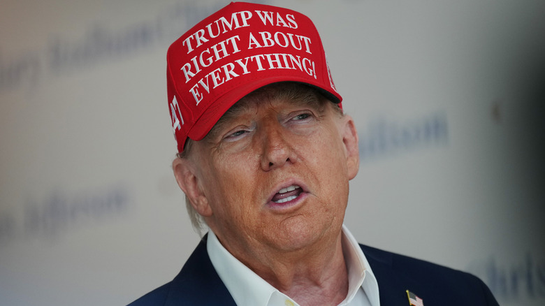 Donald Trump wearing a 'Trump was right about everything' cap.