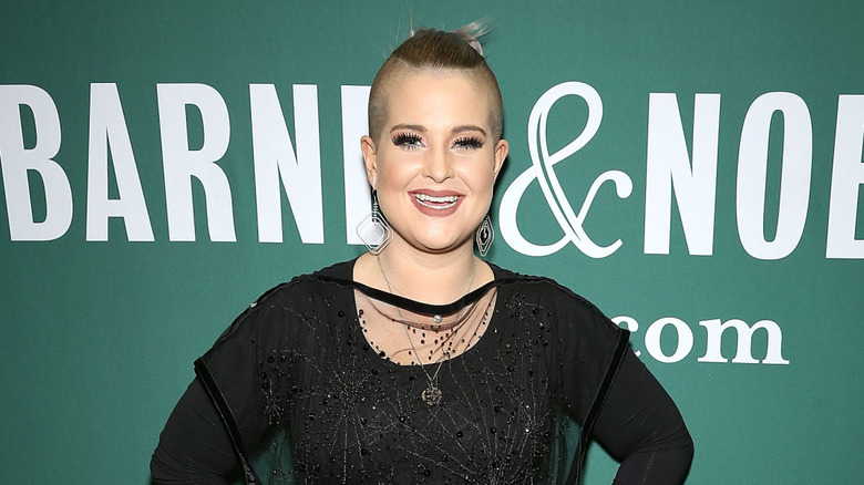 Kelly Osbourne grins at event