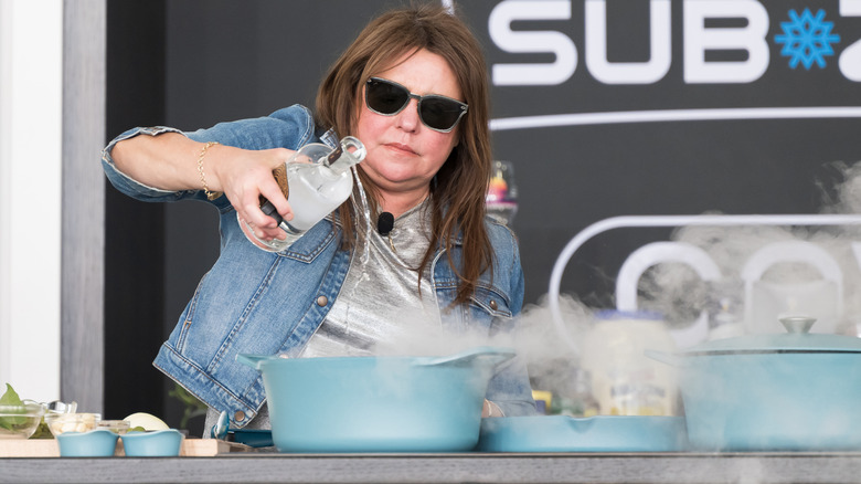 Rachael Ray doing a cooking demonstration on stage.
