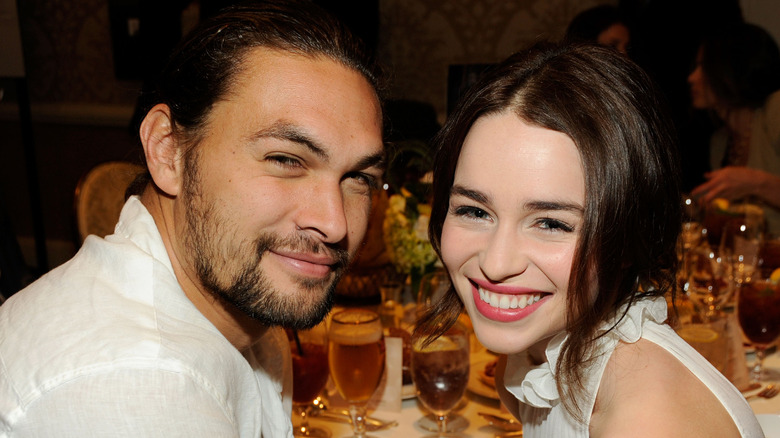 Jason Momoa and Emilia Clarke smiling