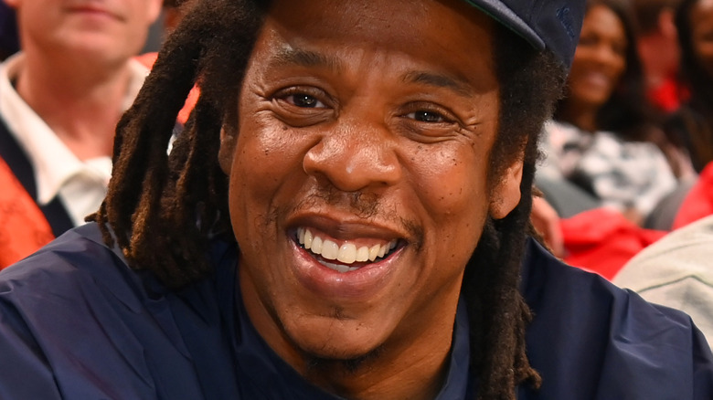 Jay-Z sitting courtside at a basketball game