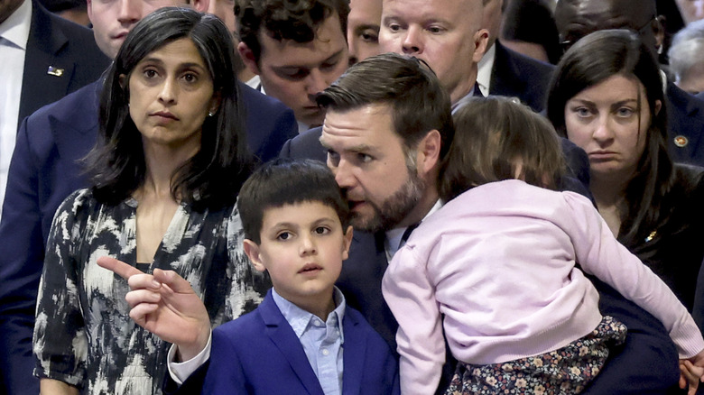 Usha Vance staring forward while JD Vance speaks to their children during Mass on Good Friday at St. Peter's Basilica