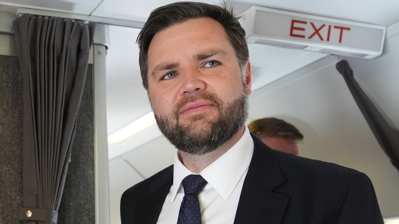JD Vance standing in front of Exit sign on Air Force Two in May 2025