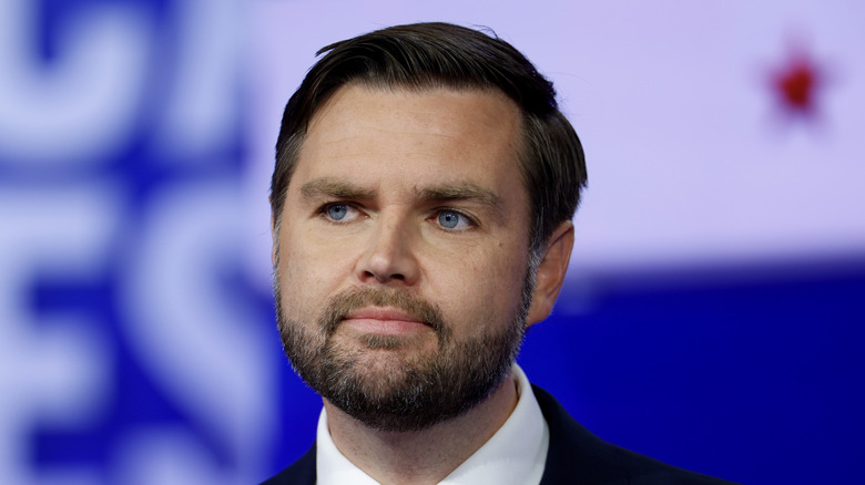 JD Vance poses in a suit