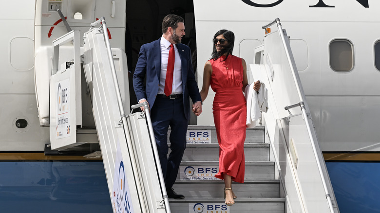 JD Vance and Usha Vance exiting an airplane holding hands